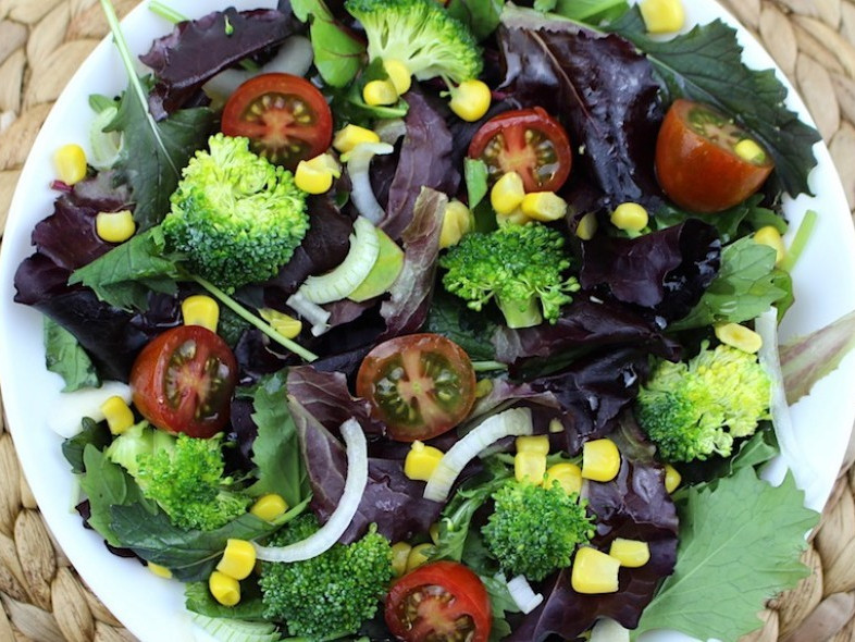 Raw broccoli, corn and cherry tomato salad